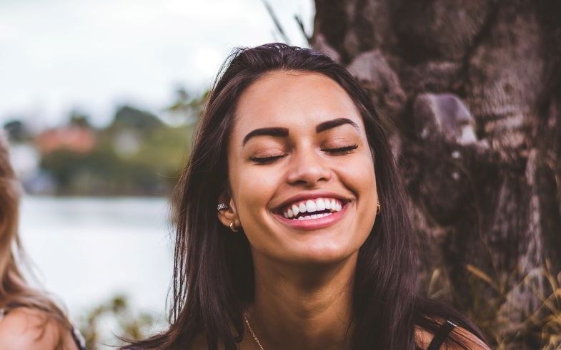 Chica con sonrisa muy blanca después de cambiar a vapeo