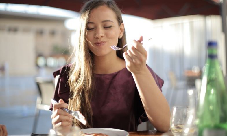 Mujer apreciando el sabor y el olor de la comida después de dejar de fumar